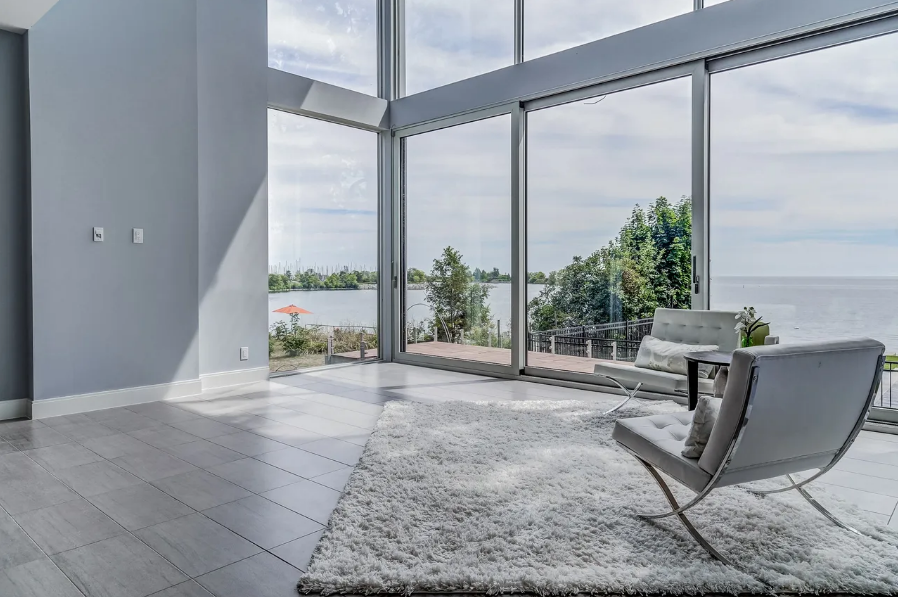 Living room with floor-to-ceiling windows overlooking water