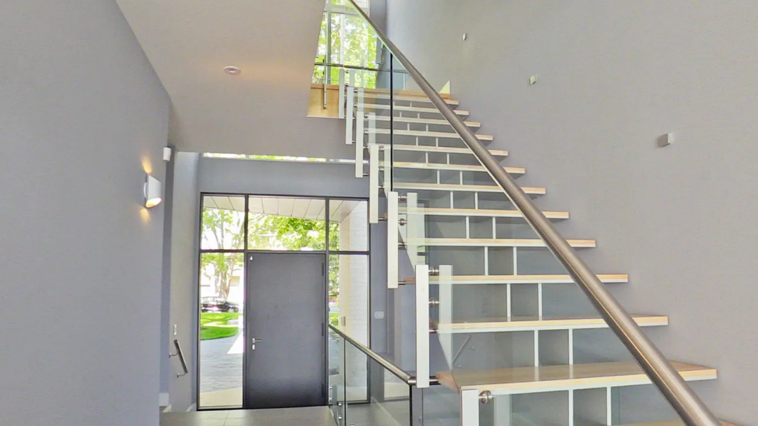 Modern floating staircase with glass railing